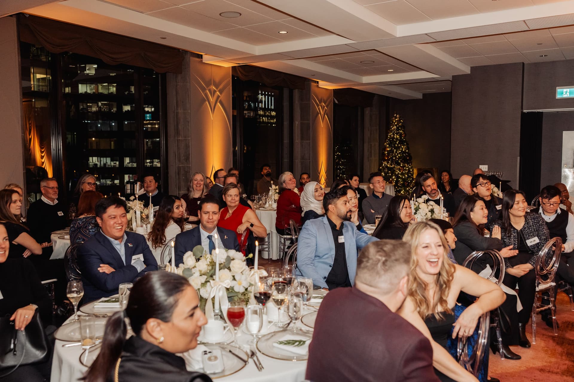 Standing-room event guests reacting to John Ha Magic