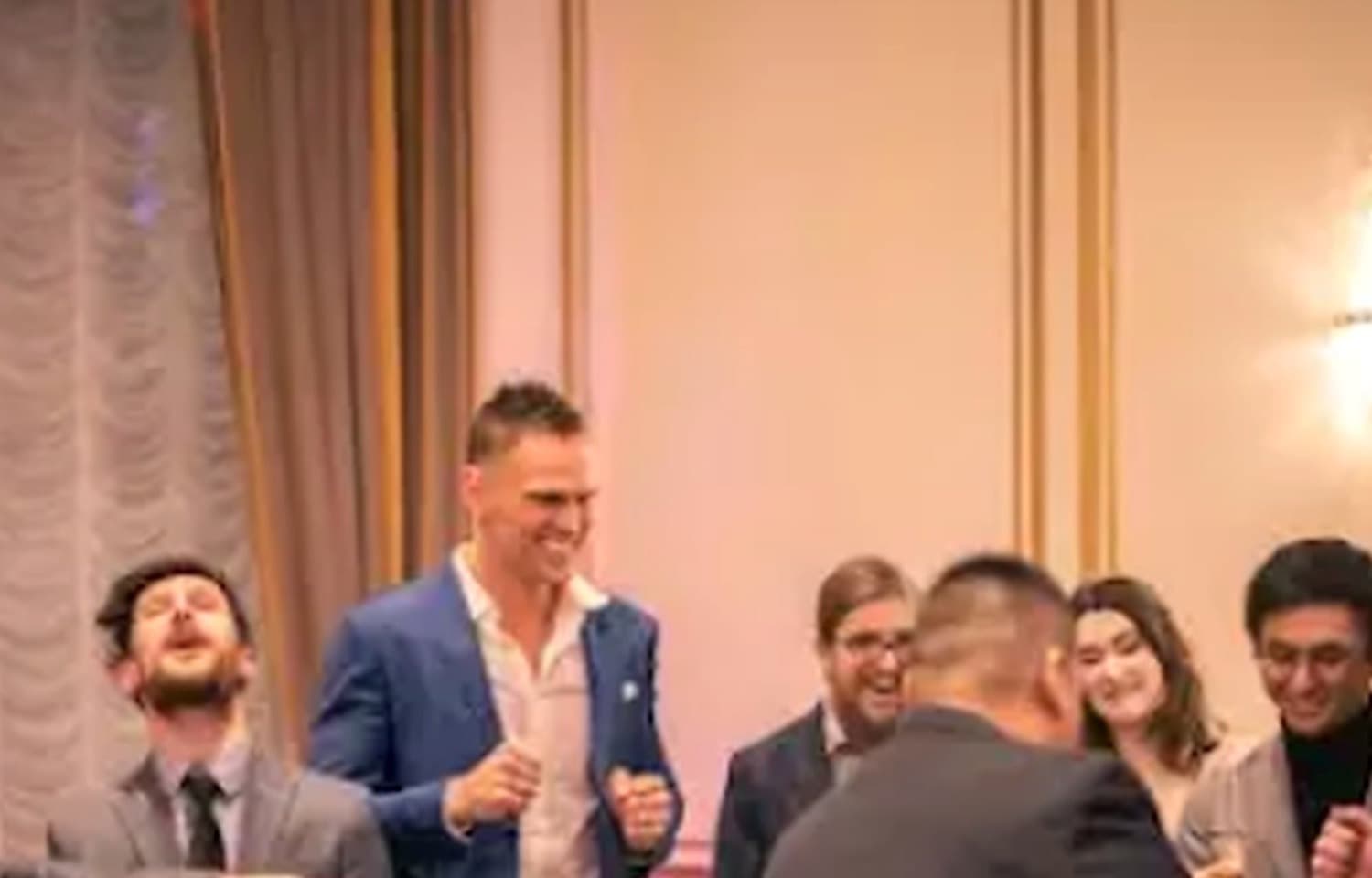 John Ha leading a stand-up magic show moment with guests reacting at an Ontario event