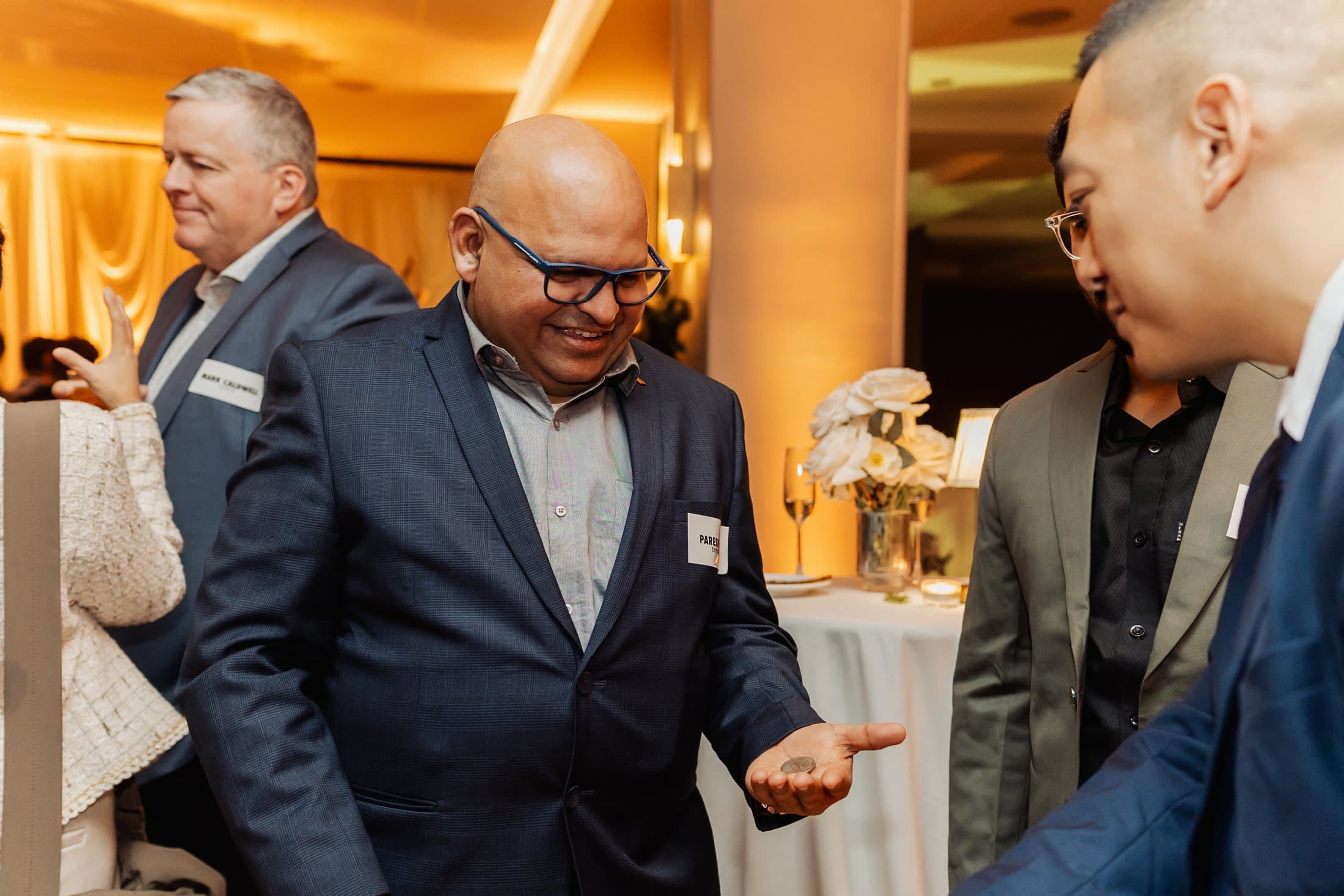 John Ha holding playing cards in formal event attire for an Ontario magician cost planning guide