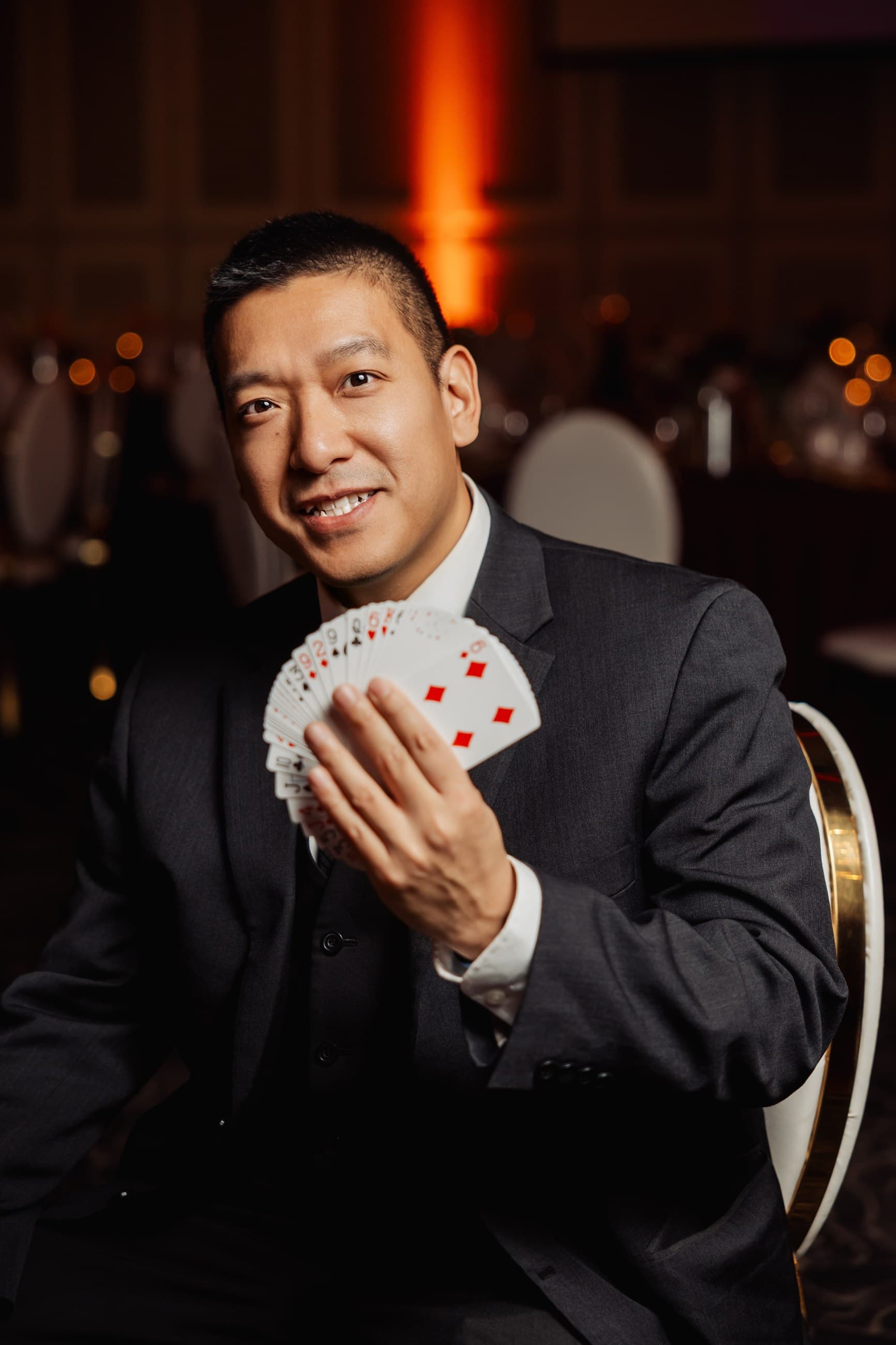 John Ha performing close-up card magic for event guests