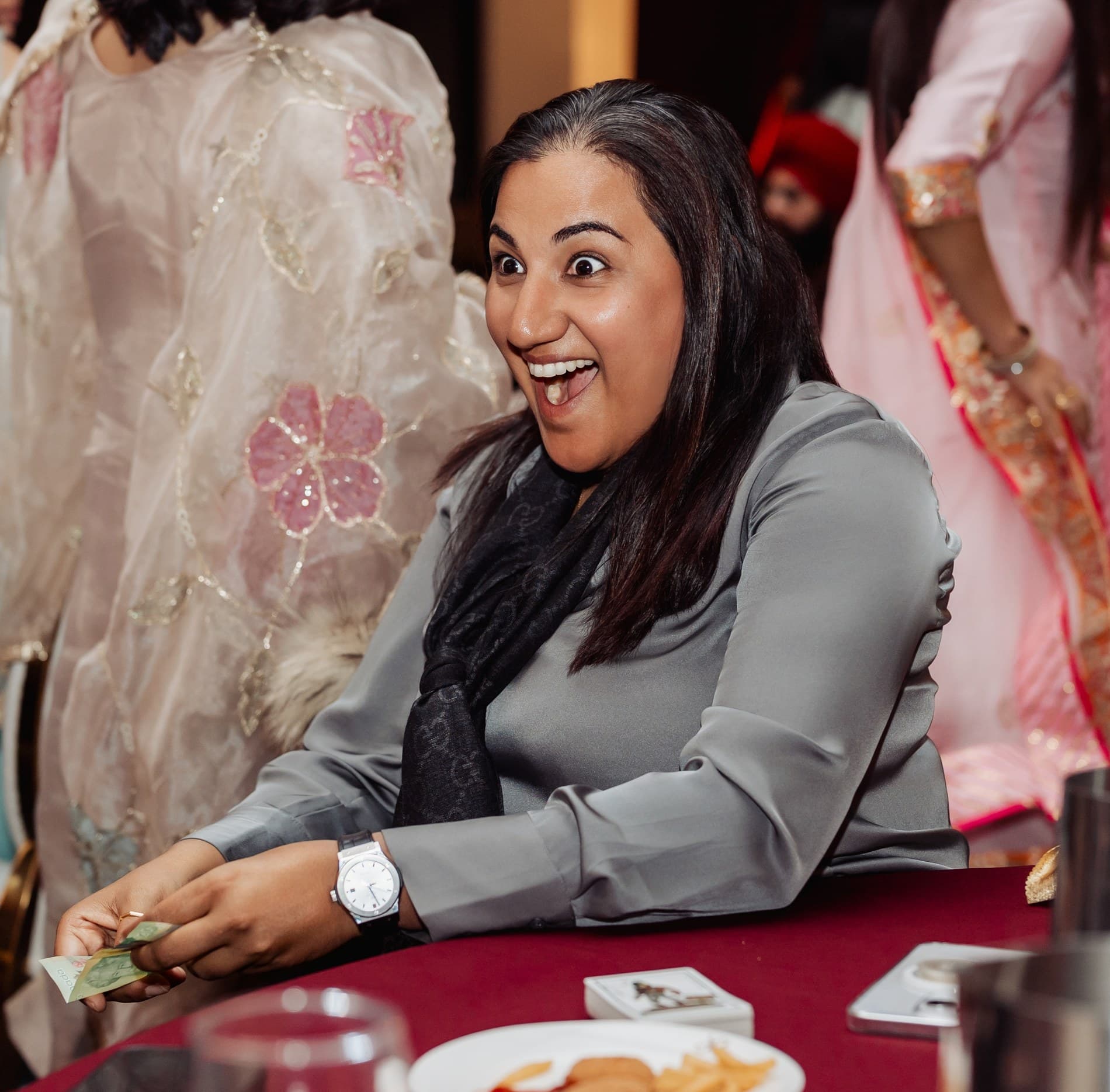A guest amazed by close-up magic at an event