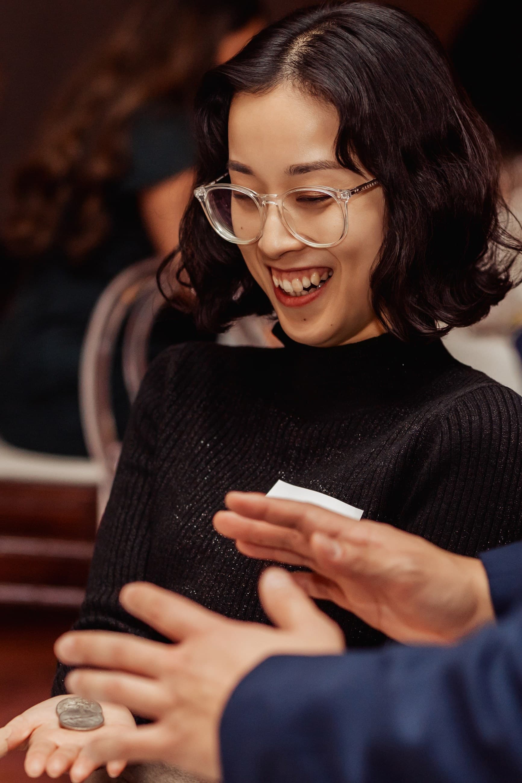 Guests laughing during close-up magic with John Ha