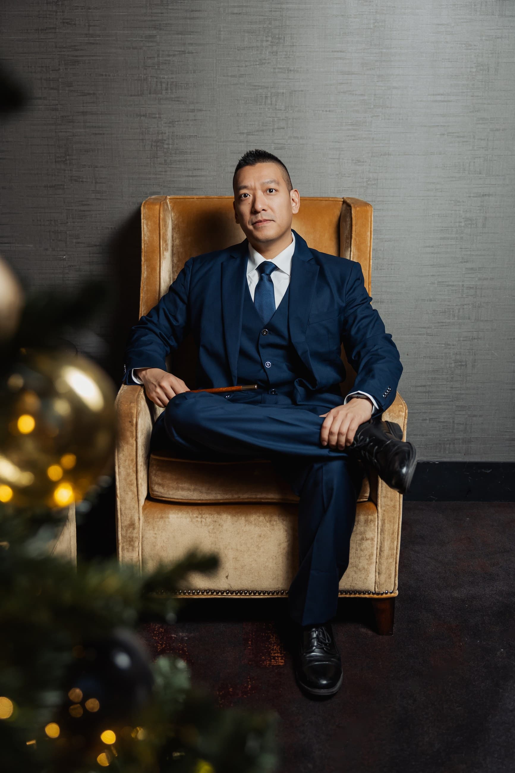 John Ha seated in a blue suit